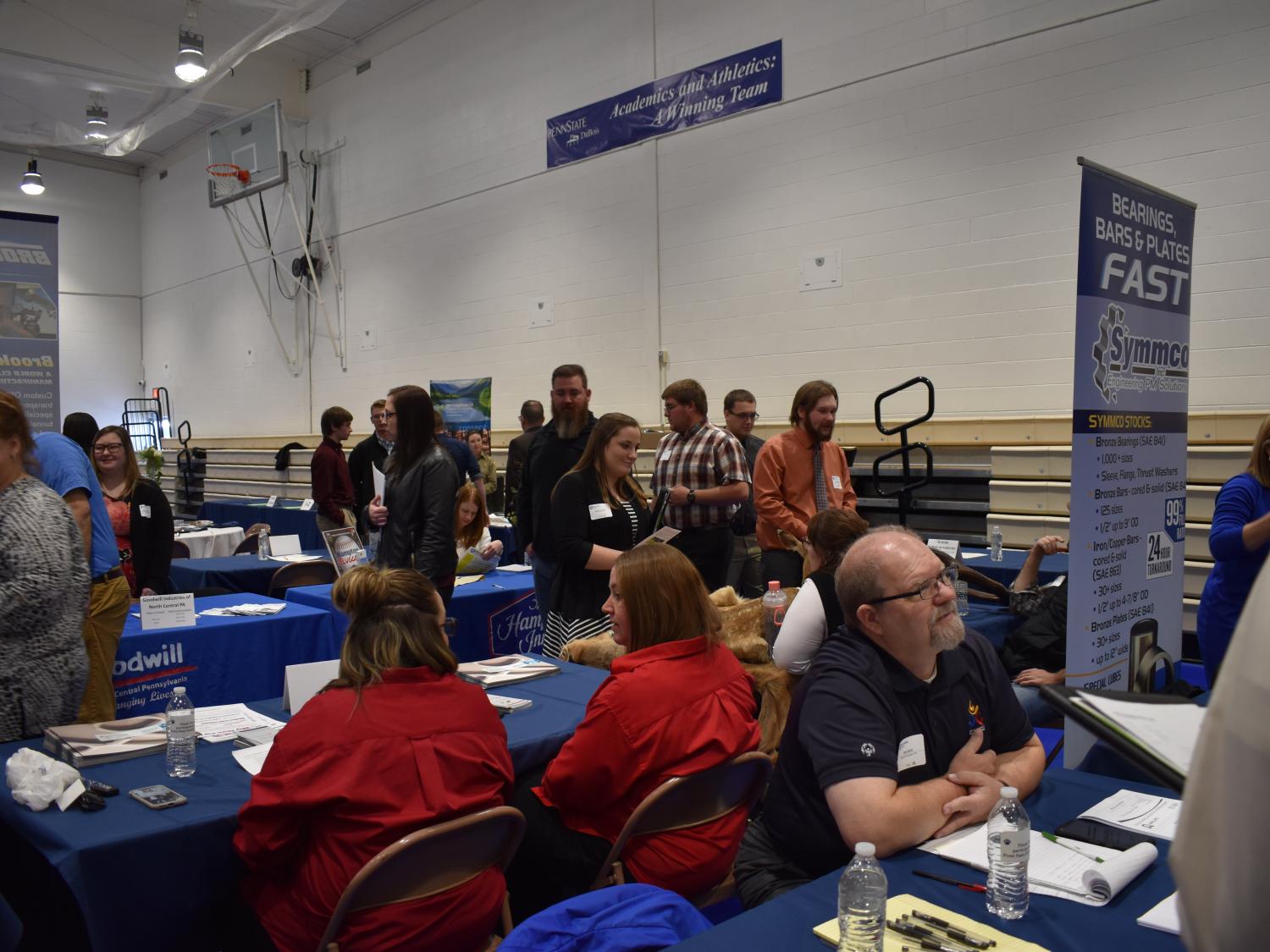 Job seekers interact with employers during last year's career fair in the campus gymnasium.  