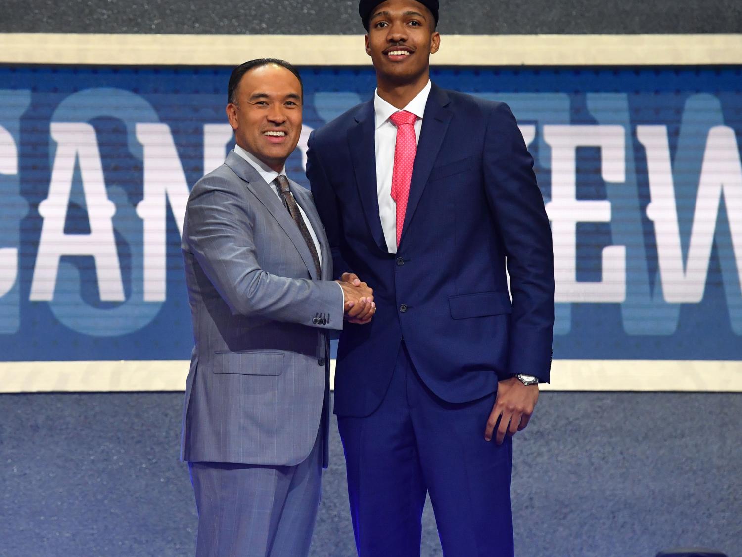 two men shaking hands at the National Basketball Association Draft