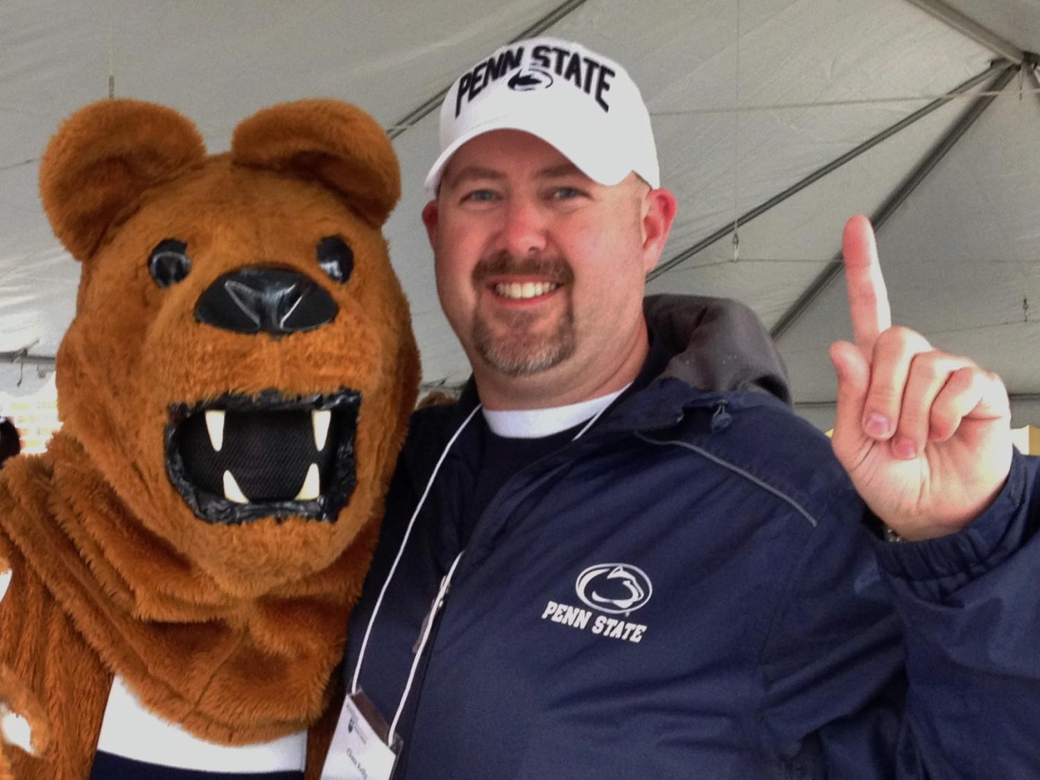 The IST student marshal for the summer of 2017, Chase Kelly, poses with the Penn State Nittany Lion. 