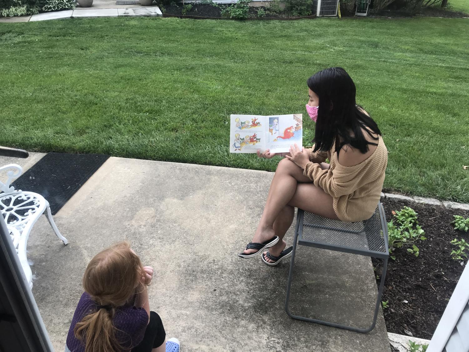 Nya Cherry reading to a neighbor