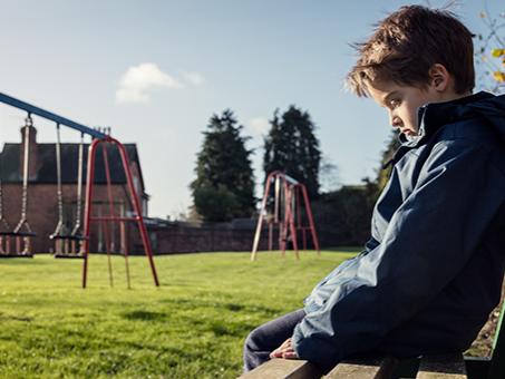 A child sits on a bench.