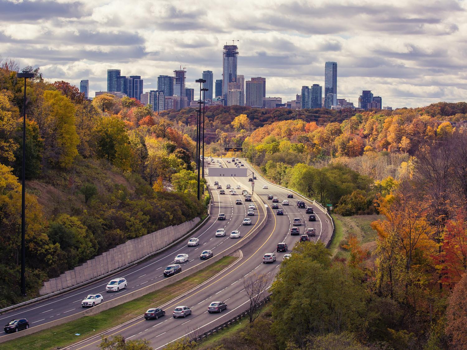 An overhead view of auto traffic driving into a city