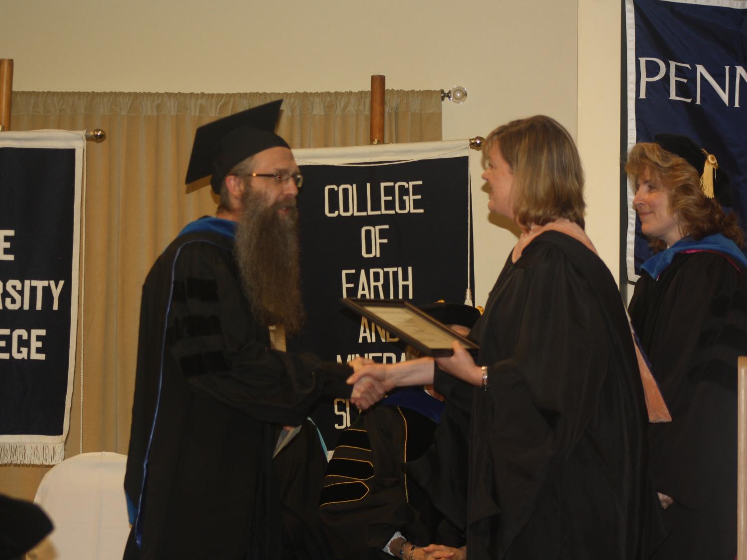 Instructor of Mathematics John Tolle receives the Educator of the Year Award.