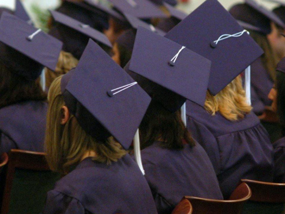 Penn State Shenango graduates' caps seen from above 
