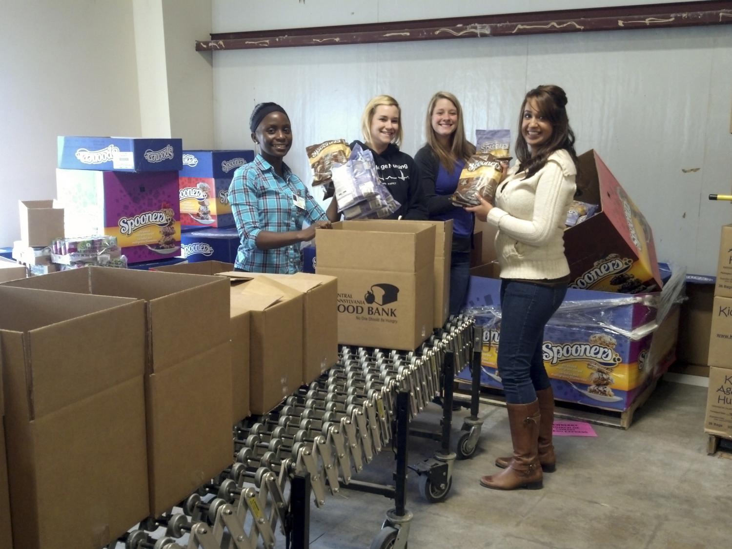 Penn College students fill boxes at the Central Pennsylvania Food Bank’s Williamsport Warehouse