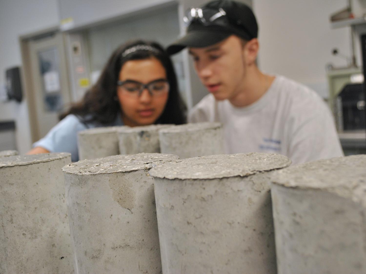 students testing concrete cylinders