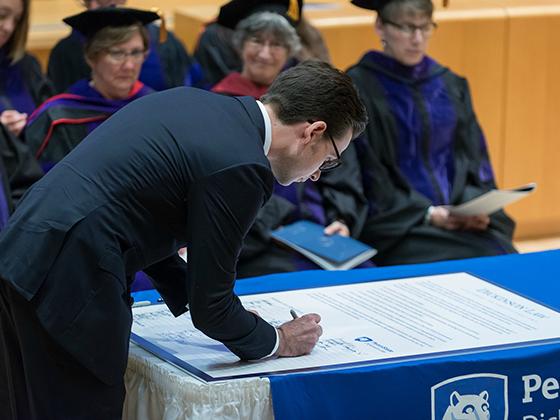 First-year Dickinson Law student Michael Slobum from Costa Mesa, CA, signs the Statement on Professionalism during Convocation on September 17. 