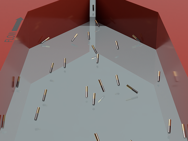 Metallic particles flow in different directions on a grey background in a red container. 