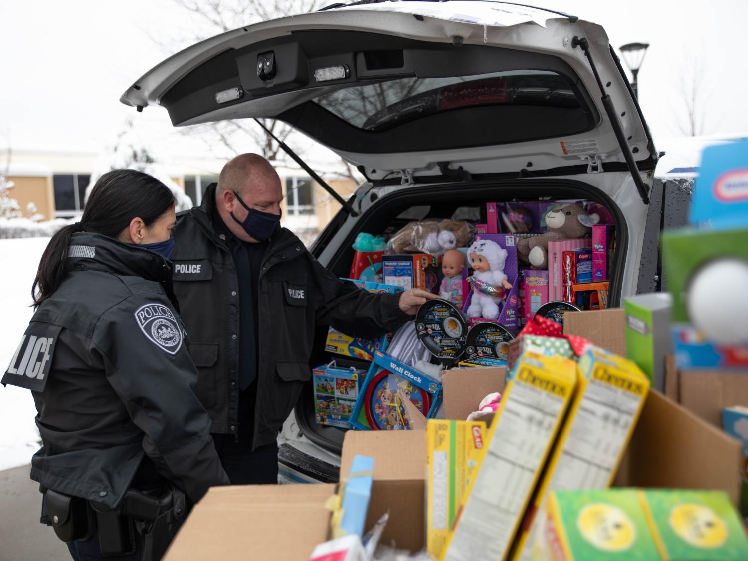Police officers load cruiser with donated items