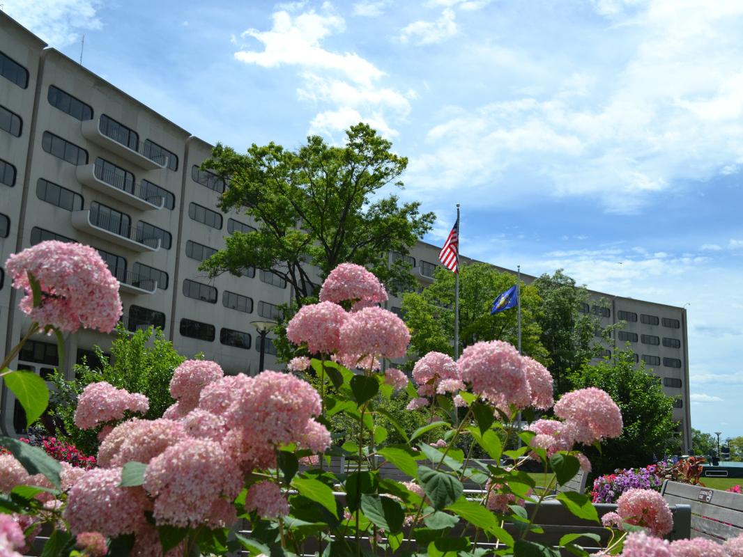 The signature crescent on the campus of Hershey Medical Center and Penn State College of Medicine. Flowers are in the immediate foreground.