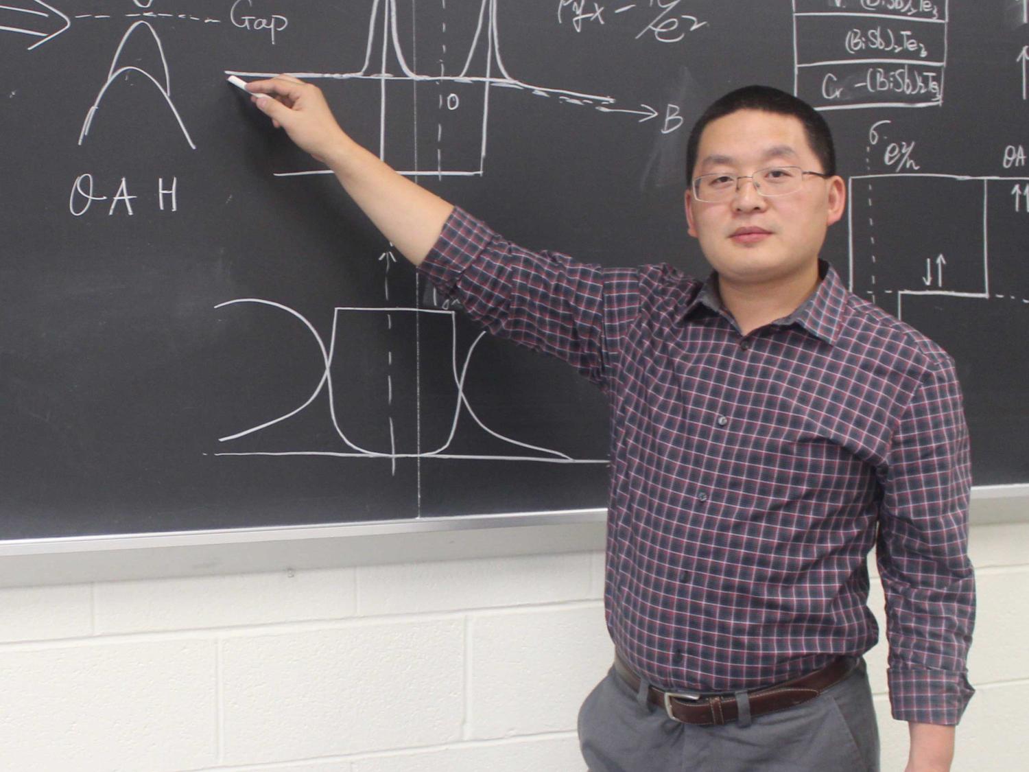 Chang writing on chalk board