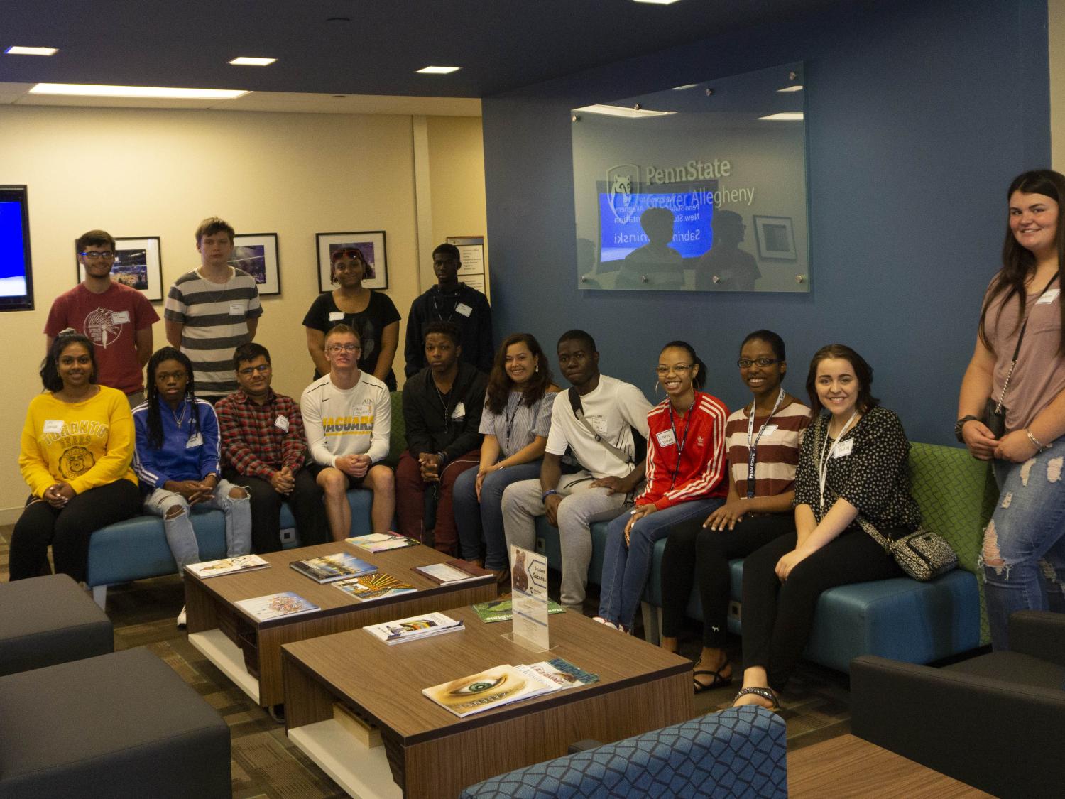 PaSSS Students sitting on furniture smiling 