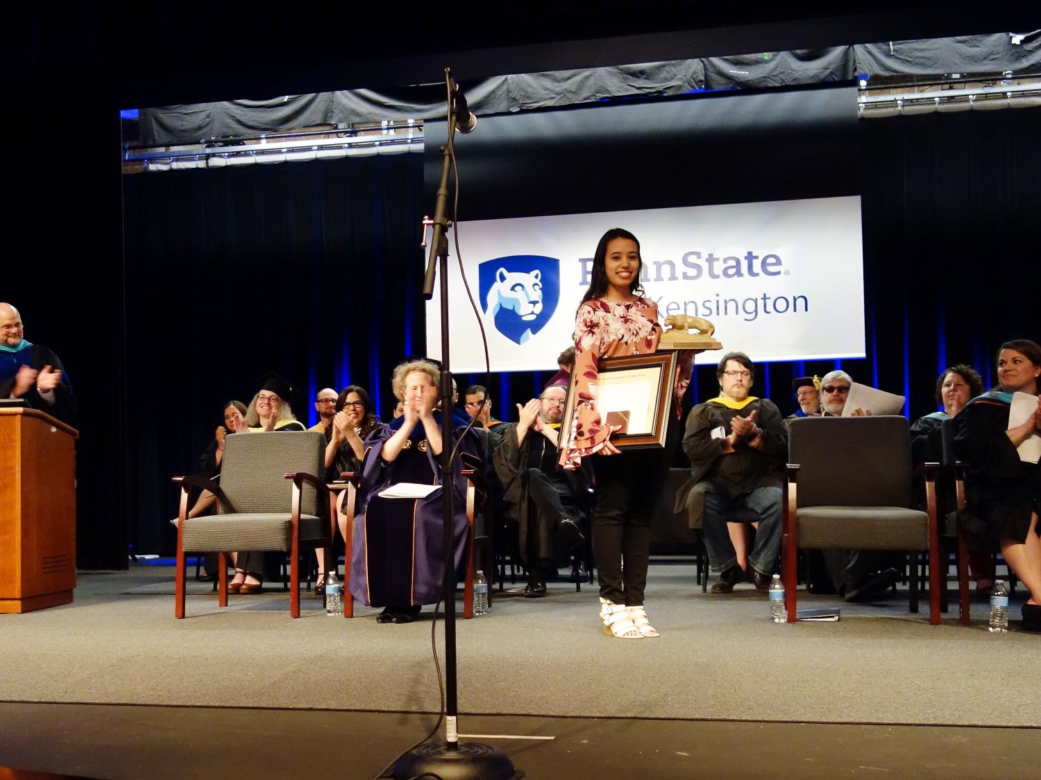 Paulina Iniguez stands on stage after receiving the 2018 Walker Award