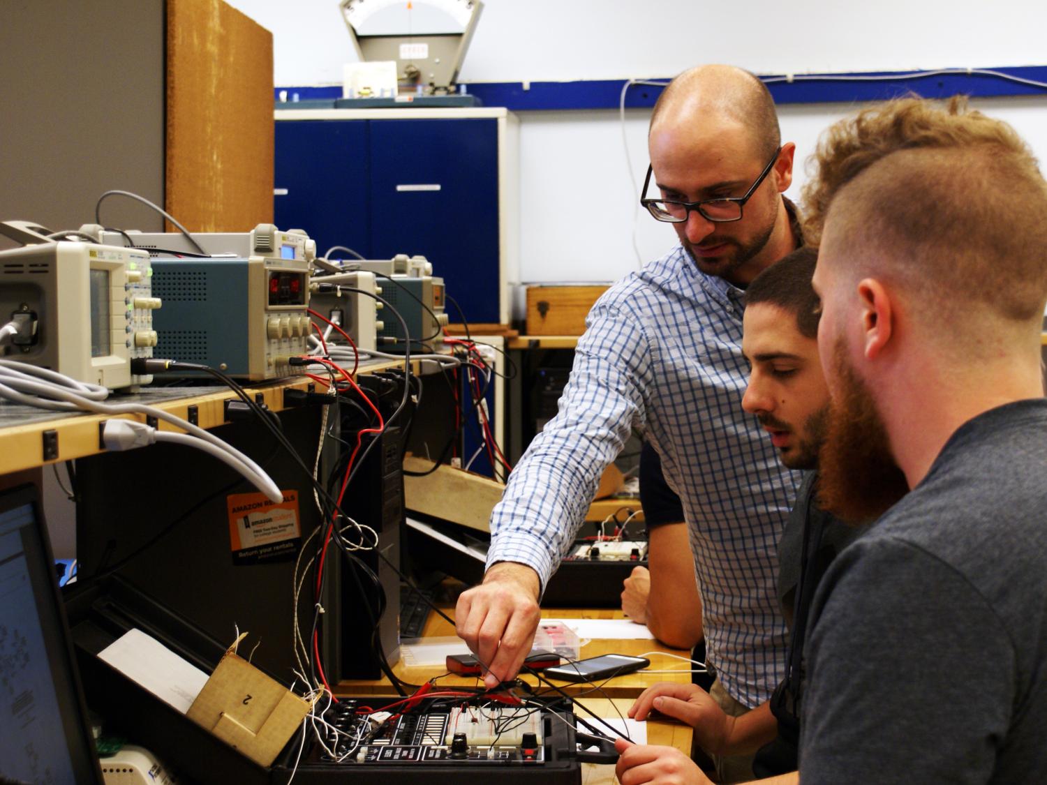 EMET professor and students in lab