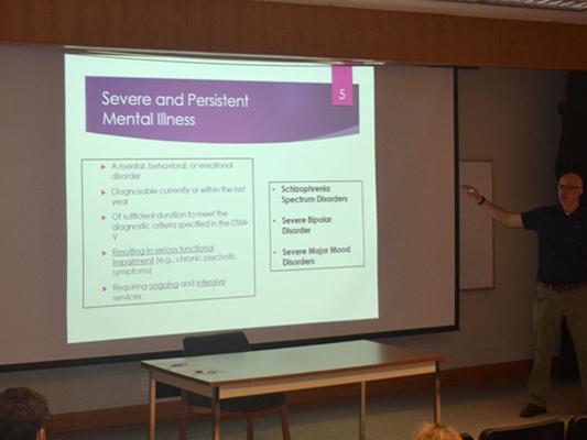 Dr. Garrett Huck presents his research on mental illness and physical activity during Penn State Wilkes-Barre's Scholarly Lecture Series.