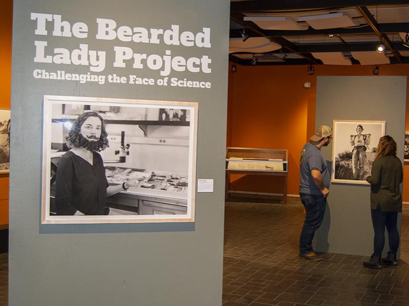 Visitors examine a new photography exhibit in the Earth and Mineral Sciences Museum & Art Gallery.