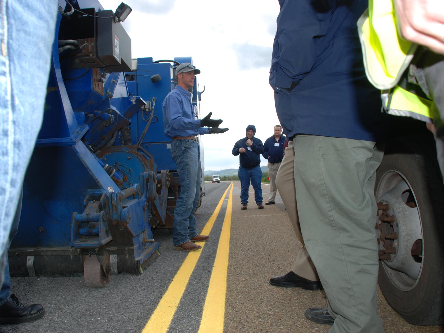 Man shows machine designed to clean asphalt