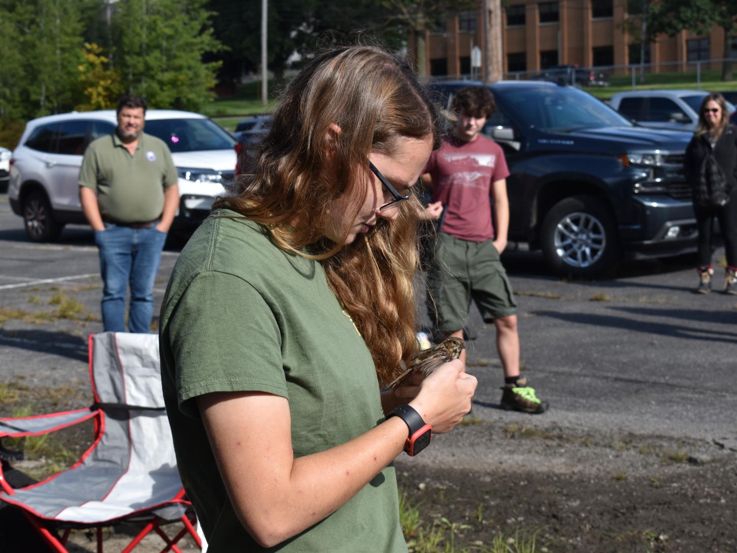 Penn State DuBois Wildlife Technology Student Piper Schwenk examines a song sparrow. 