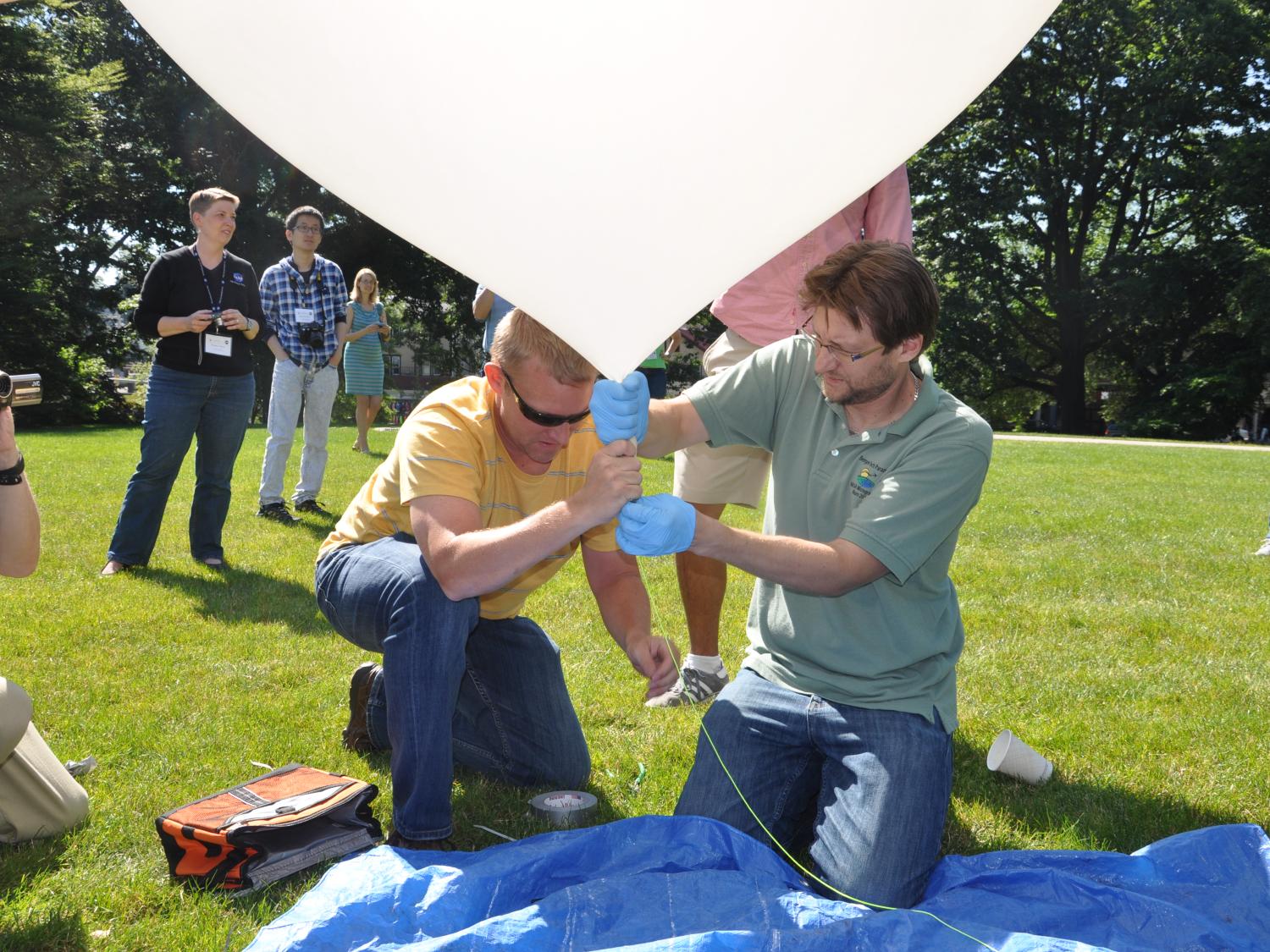 Two men prepare balloon for launch