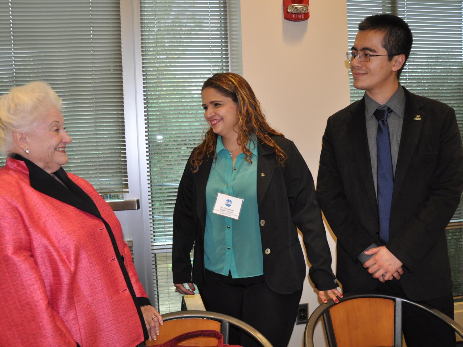 Chancellor speaks to two adults