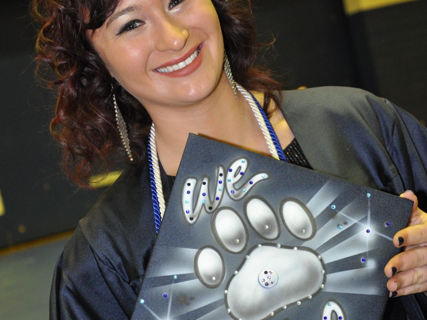 Graduate holding cap