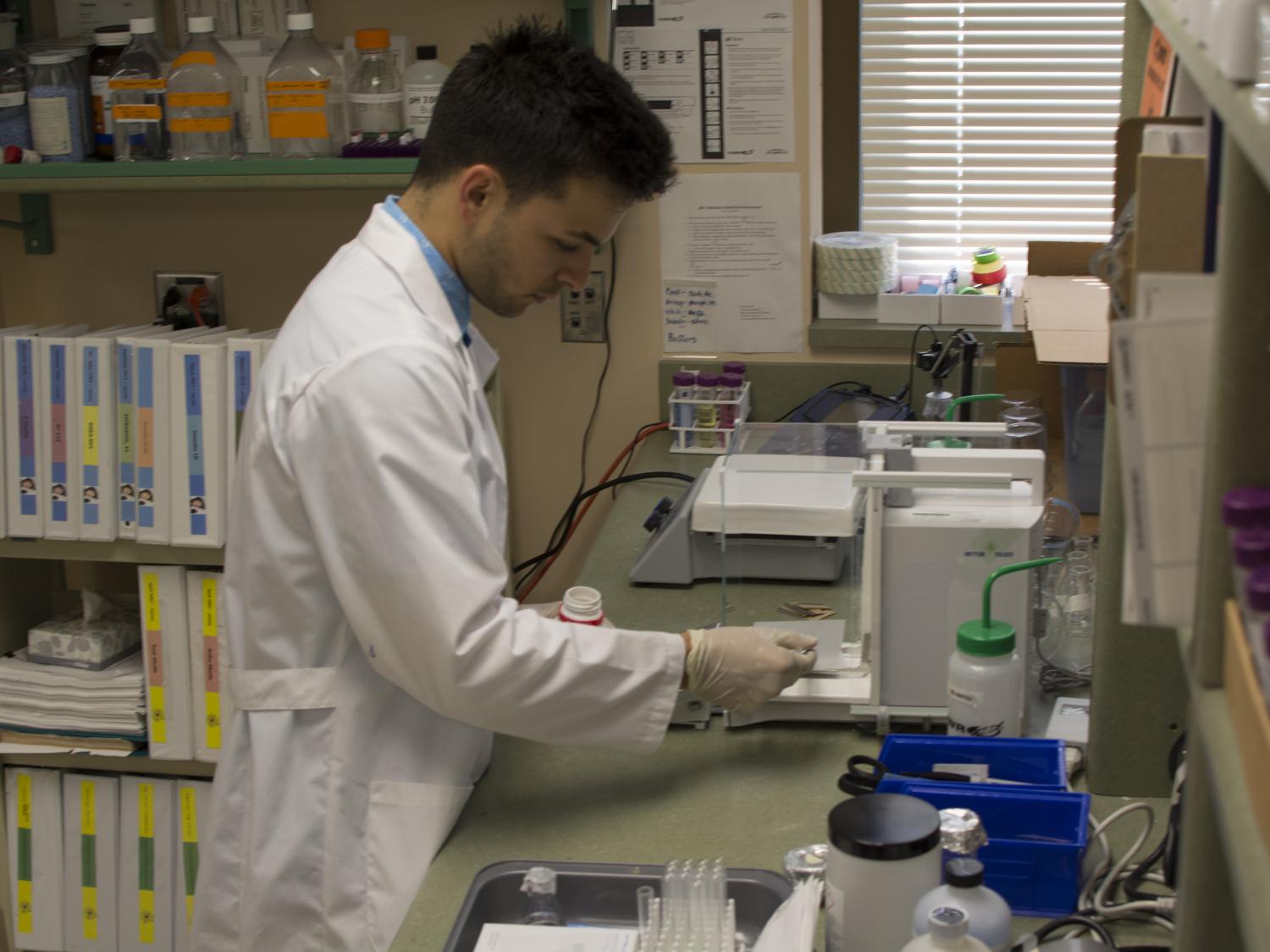 Andrew Oneglia working in a lab