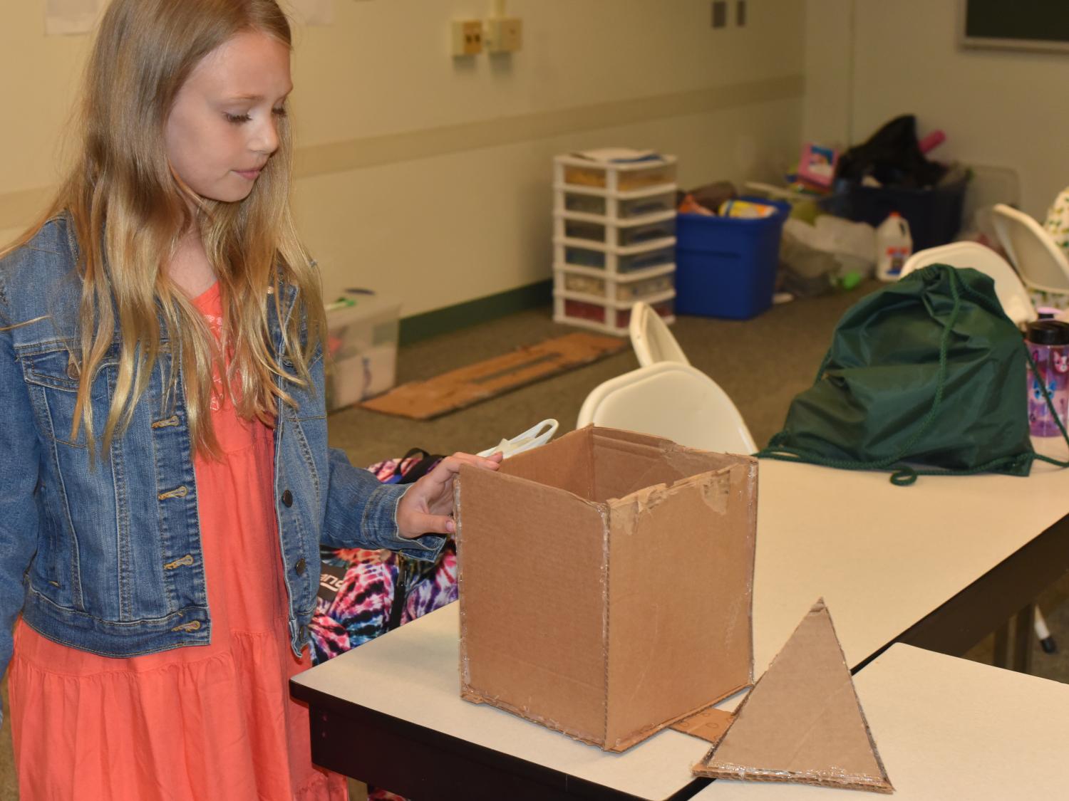 Linnea Henderson works to construct a dream home during the "Engineer and Build Your Dream Home" class at Penn State Behrend's College for Kids. 