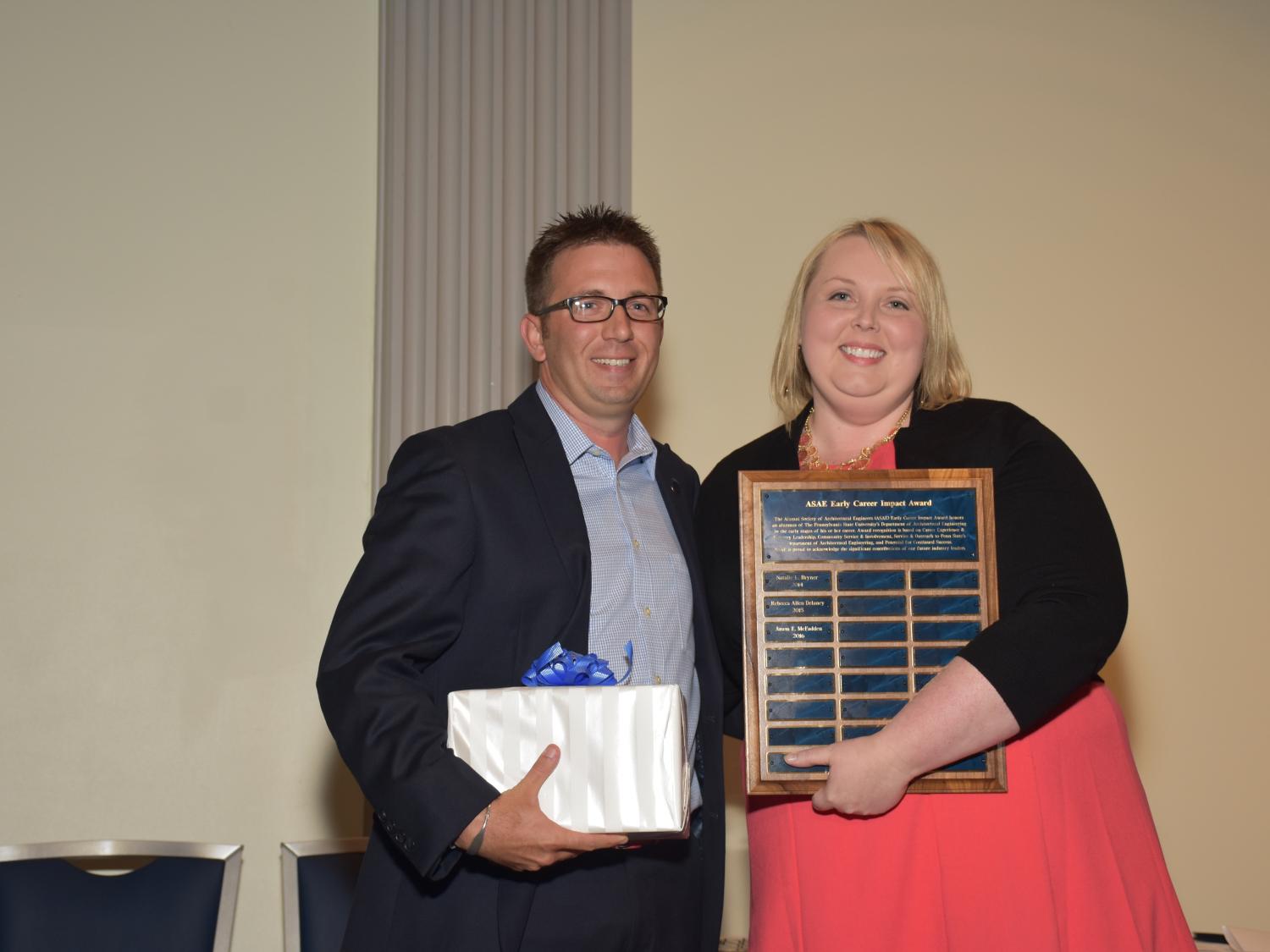 Jason McFadden receives the ASAE Early Career Impact Award from ASAE board member Jennifer Harrington. 