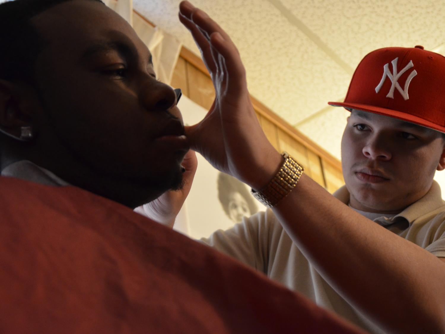James Martinez cuts a fellow student's hair