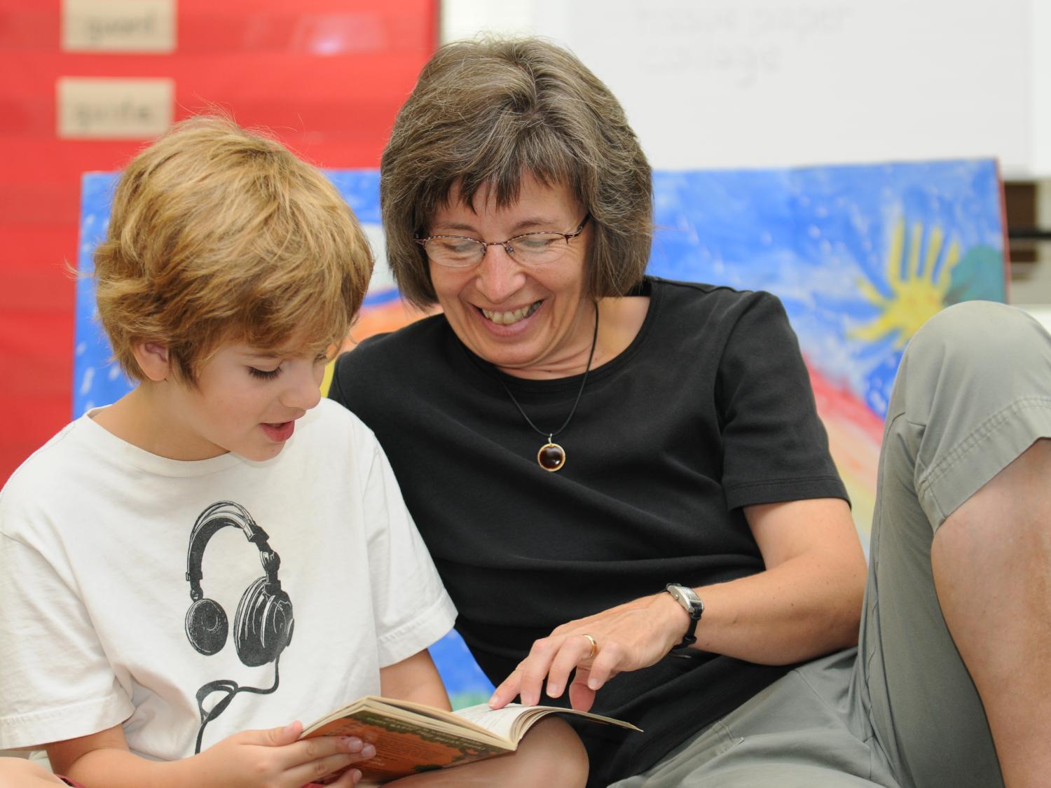 Summer Reading Camp Coordinator Kathleen Shannon reads with a student.