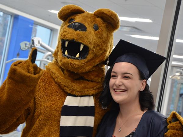 Posing with the Nittany Lion at Altoona's fall 2018 commencement