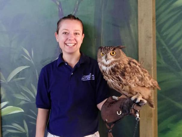 Penn State alumna Dana Piatt, who works as an animal trainer, holding an owl.