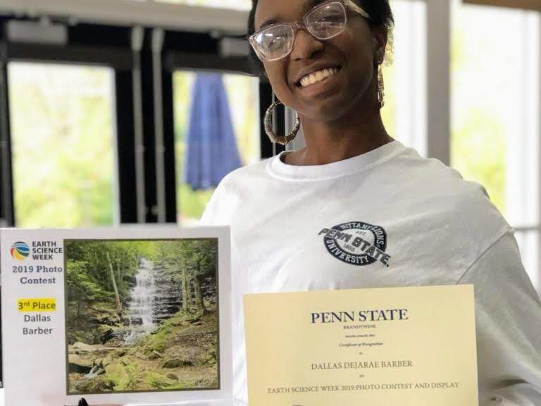 Dallas Barber displays her photo entry at the 2019 Earth Science Week Photo Contest. 