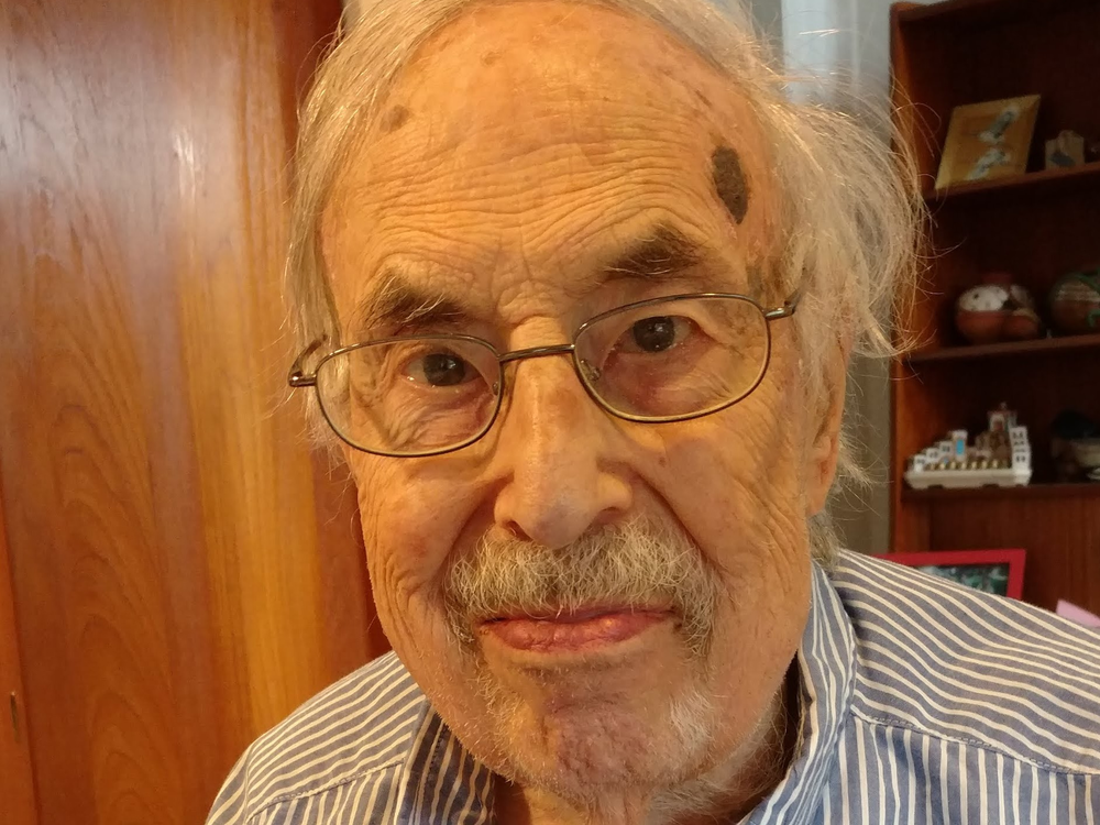 Closeup of an elderly man in his kitchen.