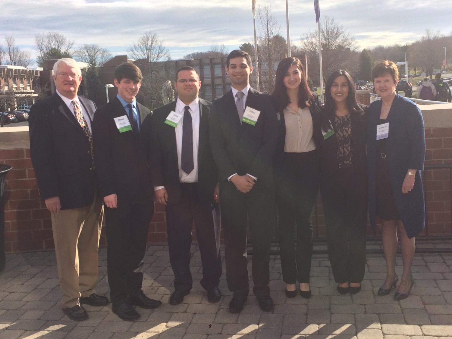 The second place debate team with their coach and adviser