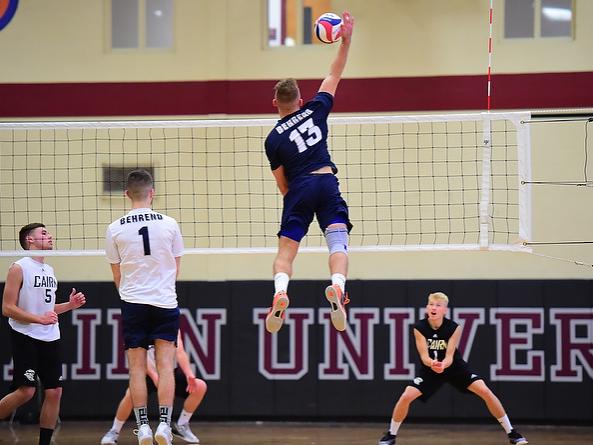 Penn State Behrend volleyball player Dillon Hildebrand leaps to hit the ball.