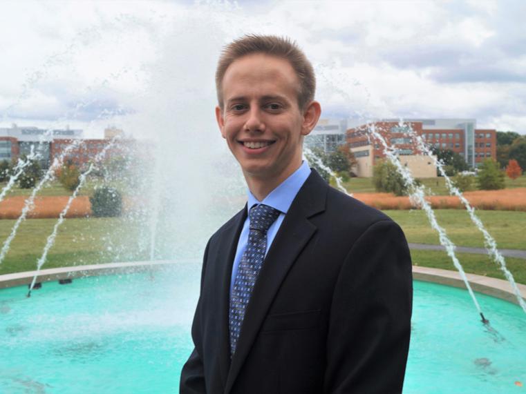 Andrew Doberstein in front of the Penn State Arboretum fountain.