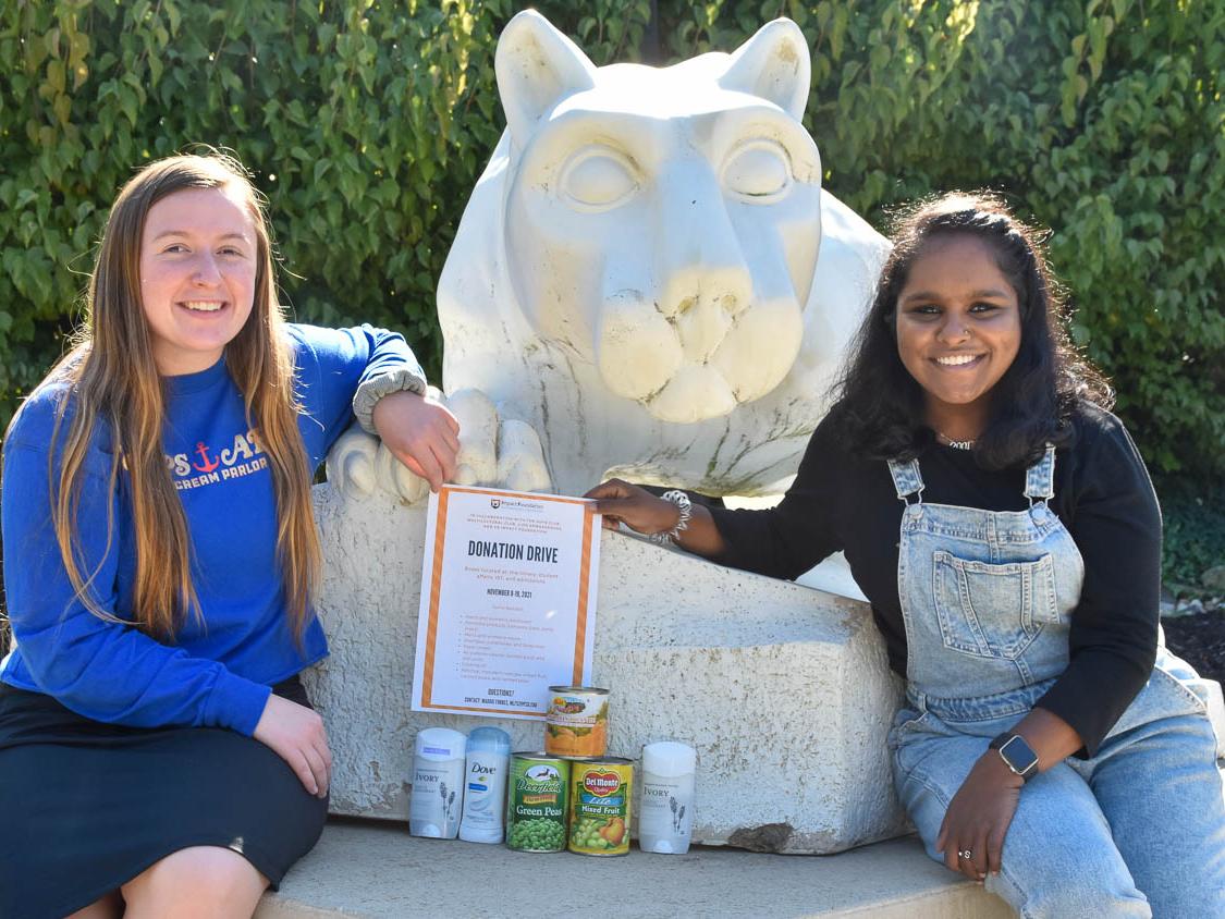 Two students at Nittany Lion Shrine