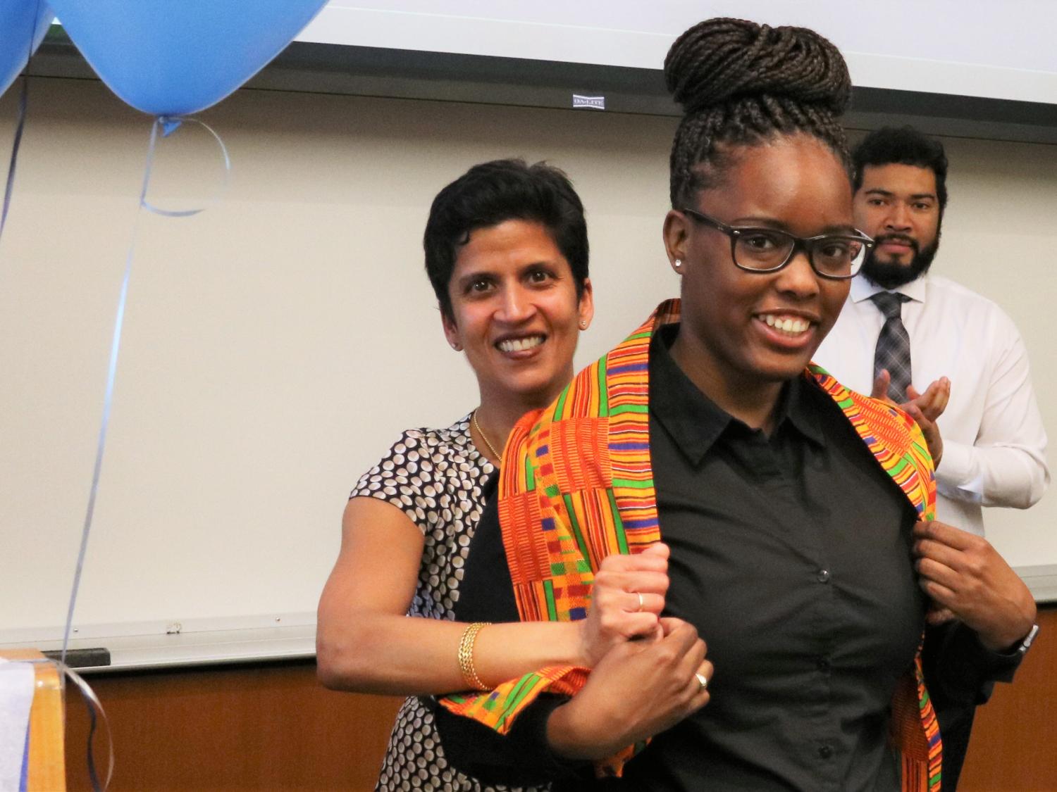 Penn State Law professor Shoba Wadhia dons the Kente on graduating student Brianni Frazier at the "Donning of the Kente" ceremony on April 21.