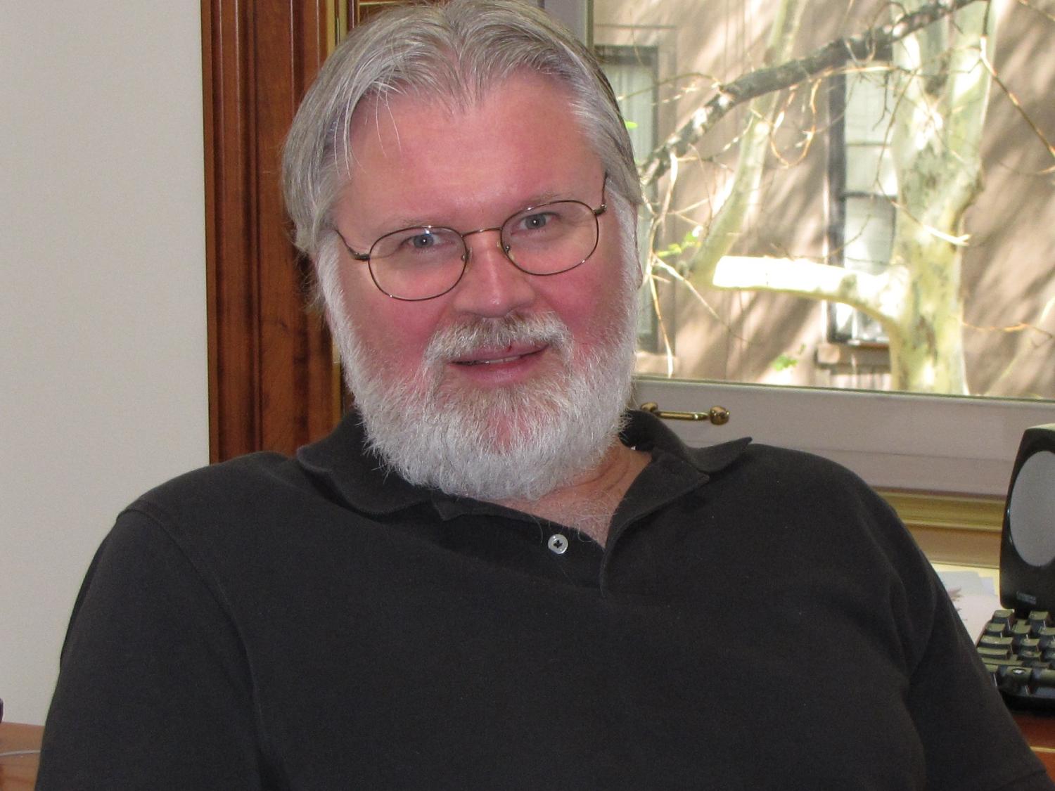Douglas Massey head shot in black button-down shirt.