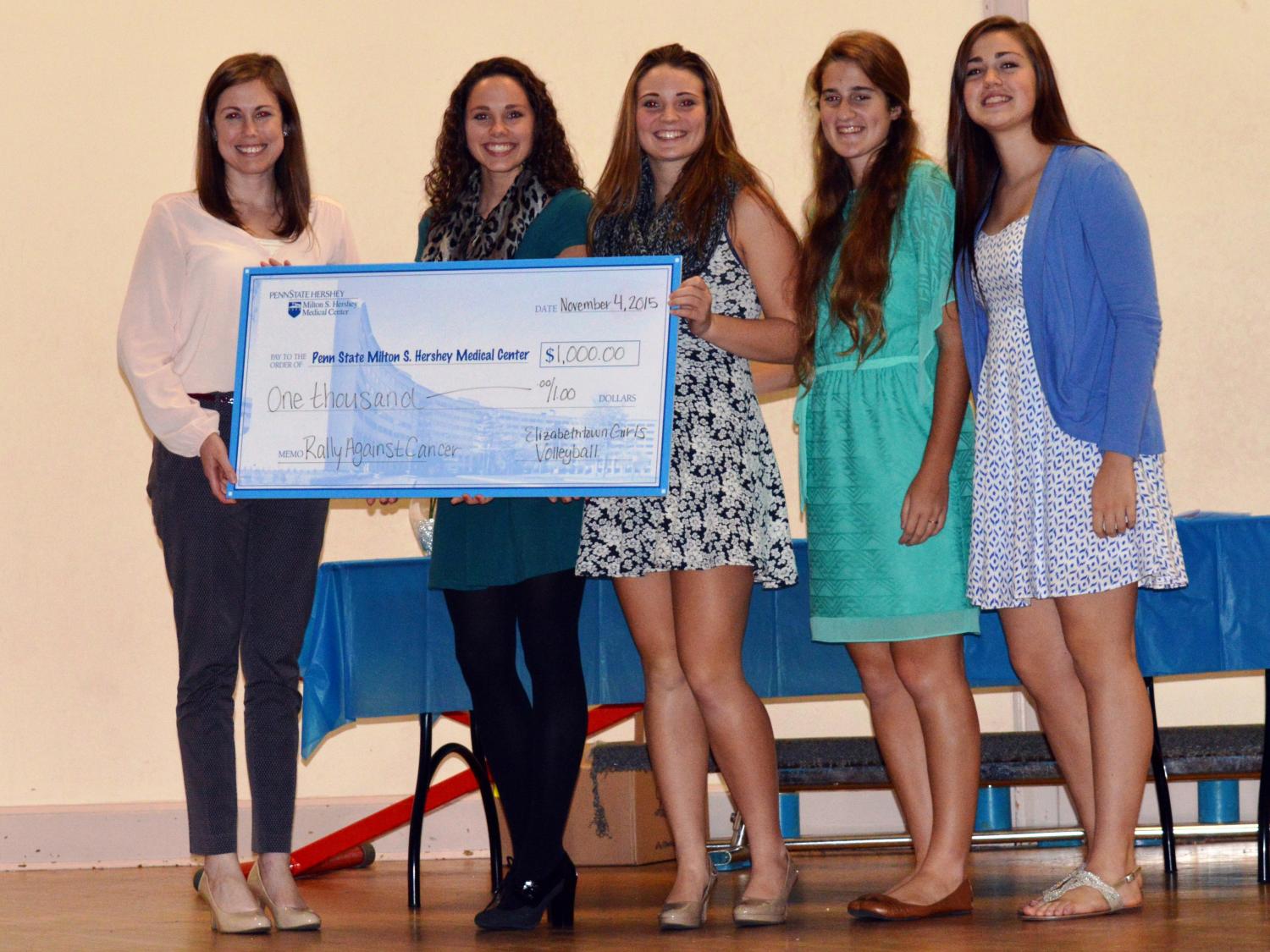 Representatives of Penn State Hershey and the Elizabethtown High School girls' volleyball team pose for a photo.
