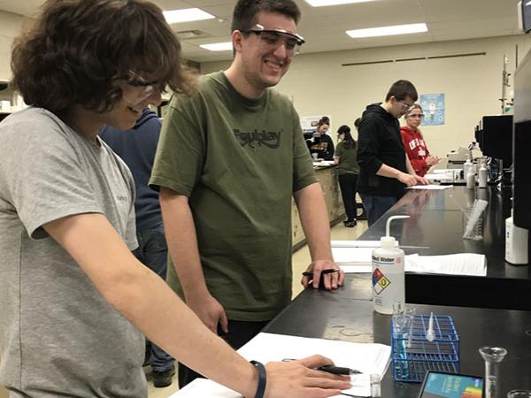 Two males students looking over equipment in chemistry lab at Shenango campus.