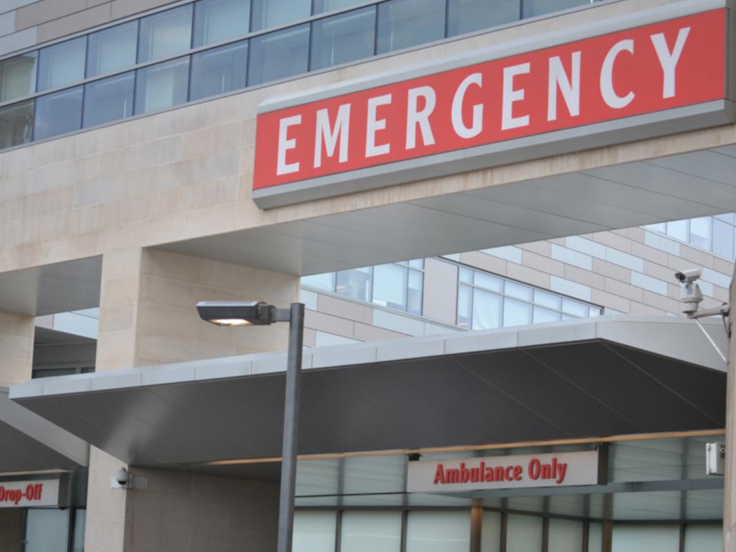 A close-up image of a large sign reading “EMERGENCY” at the Hershey Medical Center Emergency Department entrance.