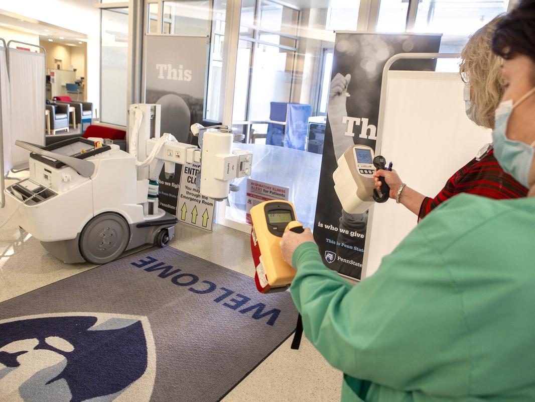 Diane Heck, left, radiologic technologist, and Karen Wagner, radiation safety officer, use pressurized ionization survey meters to test low-level ionizing radiation at St. Joseph’s former main entrance that was converted to a curbside X-ray service.