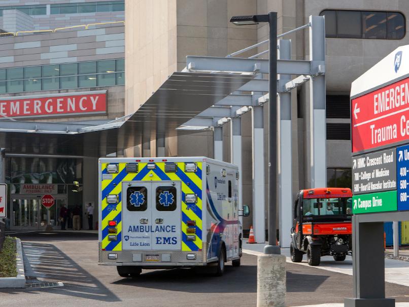 An ambulance sits outside of an emergency department