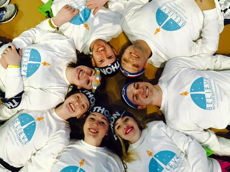 EMS THON dancers laying on ground in a circle