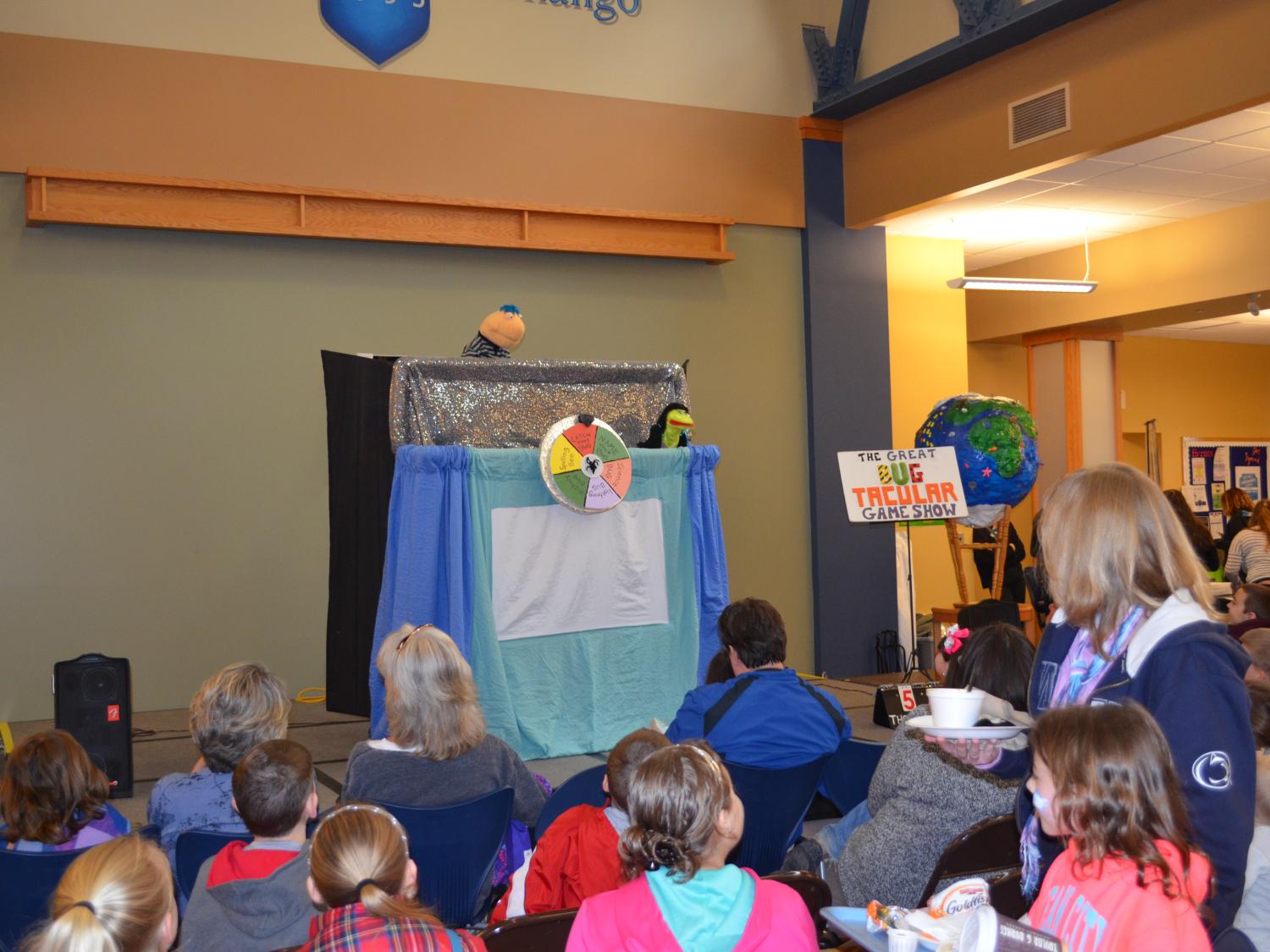 Children gather to watch much aniticpated puppet show during Earth Fest 2015