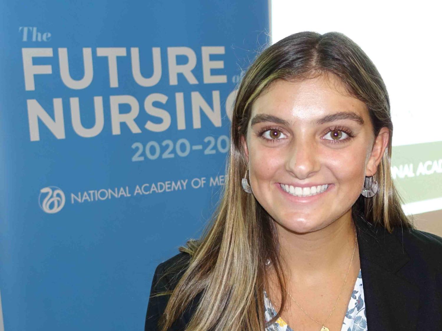 Elise Krikorian poses in front of Future of Nursing Campaign sign