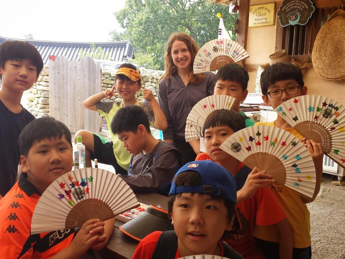 Penn State graduate Emily Sabo stands with students on a from one of the fourth-grade classes she teaches in South Korea.