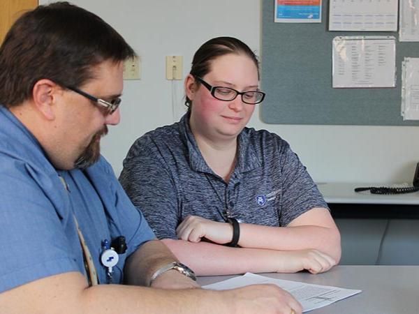 A man and a woman sitting at a table.